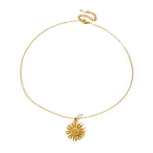 Detail shot of golden sun pendant necklace with S.STEEL hallmark on stainless steel clasp