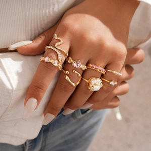 Detail view of 8pcs gold ring set with heart gems and snake design on hand