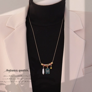 Vintage gold necklace with colorful enamel butterfly pendant and pearl on chic model