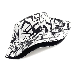 Detail of white cotton bucket hat with black graffiti letter prints and wavy brim edges