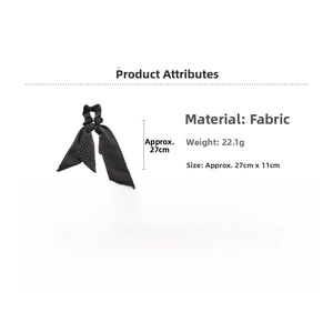 Detail view of black floral ribbon hair tie with white polka dots pattern and fabric texture