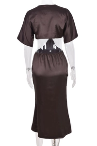 Detail view of brown backless crop top and satin skirt set with lace-up back design