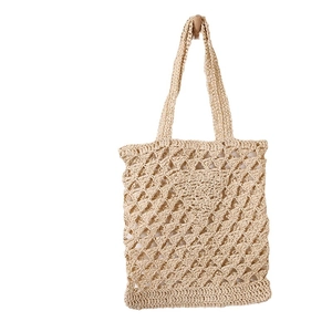 Beige hollow-out straw woven shoulder bag for beach vacations with minimalist mesh design
