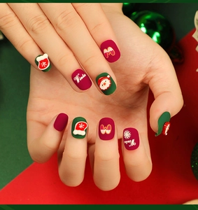 Detail of Christmas press-on nails featuring Santa and snowflake 3D designs