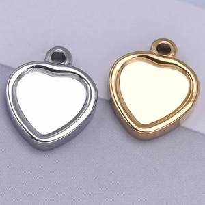 Macro view of gold and silver heart-shaped 304 stainless steel pendants for DIY jewelry