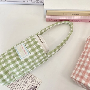 Close-up of quilted cotton plaid cup sleeves in pink and green with soft padded handles