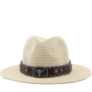 Detail of vintage straw cowboy hat featuring leather band and metal bull head ornament