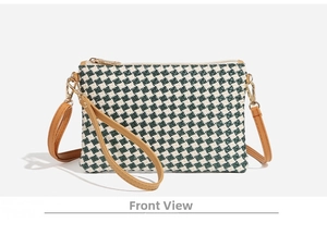 Front view of green and white houndstooth woven envelope bag with brown faux leather trim