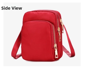 Close-up of red nylon crossbody phone bag with three golden zippers and adjustable strap