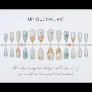 Detailed view of ocean-themed handmade press-on nails with 3D starfish and pearls
