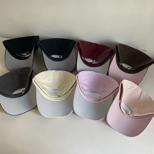 Detailed top view of 8 multi-color cotton baseball caps with checkered visors and adjustable straps