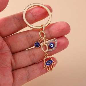 Vintage Hamsa Hand and Evil Eye keychain in gold metal with sparkling rhinestones