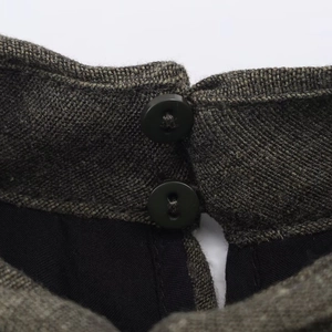 Close-up of dark grey tweed balloon dress featuring double buttons and black lining
