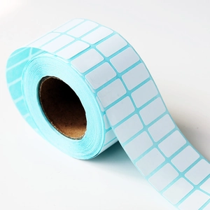 Close-up of a roll of white rectangular self-adhesive labels for diamond painting DIY