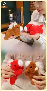 Macro shot of plush pony magnets in red and brown with soft mane for decor