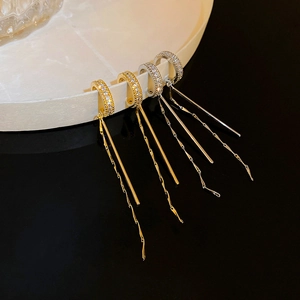 Detail of C-shaped long tassel ear cuff with gold and silver plated cubic zirconia