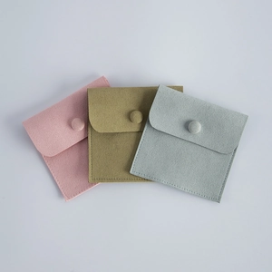 Detail of colorful velvet jewelry pouches with snap button closure in various colors