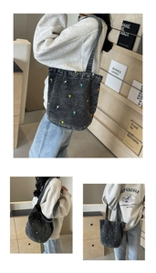 Detailaufnahme der bunten Tulpenstickerei auf der grauen Denim-Beuteltasche