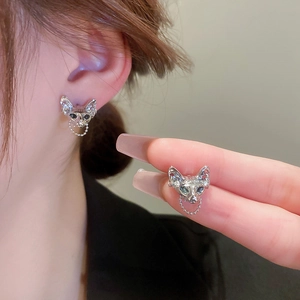 Sphinx cat head silver stud earrings with delicate hanging chains on ear display
