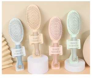 Detail of four colorful hairbrushes with cat ear handles on a circular stand