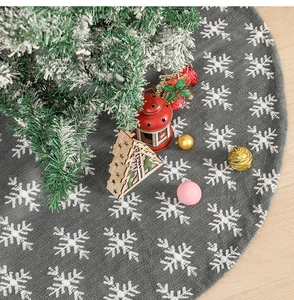 Detailed top view of grey plush Christmas tree skirt with white snowflake patterns