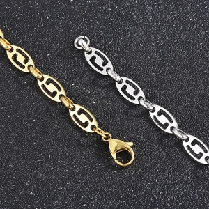 Gold and silver stainless steel hollow oval coffee bean link necklaces on black background