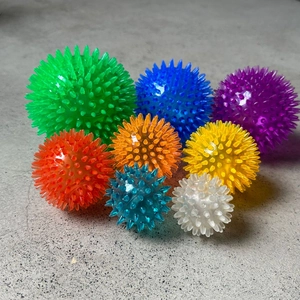 Detailed view of colorful TPR pet spike balls in various sizes and vibrant colors
