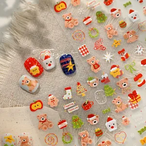Detailed macro of 3D Christmas nail art stickers with bears, trees and stockings