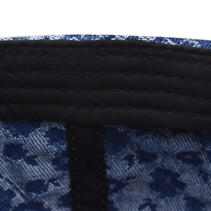 Close-up of internal sweatband and reinforced stitching on floral denim baseball cap