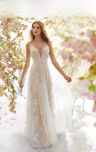 Detailed view of the sleeveless V-neck lace wedding dress with floral tulle overlay