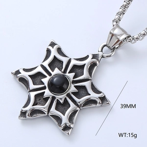 Macro detail of vintage octagonal star pendant with black gemstone, 39mm in height