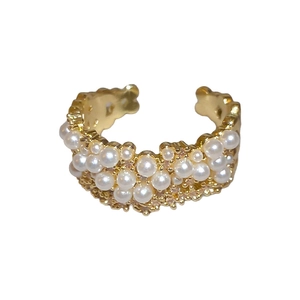 Elegant gold-plated open ring with white pearls and micro-pave crystals on white background