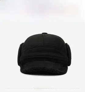 Front view of black winter trapper hat featuring faux suede fabric and fleece ear flaps
