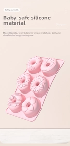 Detail of 6-cavity pink silicone donut mold with various flower and ring patterns