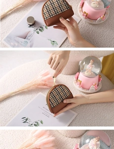 Close-up of mini houndstooth canvas coin purse with brown leather trim and metal zipper