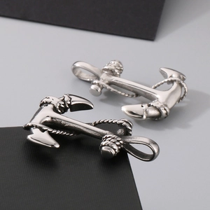 Macro detail of silver nautical anchor pendants with intricate 3D rope texture