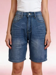 Detailed front view of high-waisted denim shorts with five pockets and stone wash finish