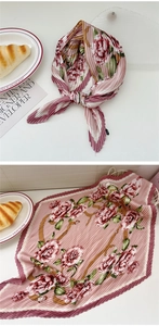 Detailed view of pink rose print pleated square scarf tied as an elegant necktie accessory