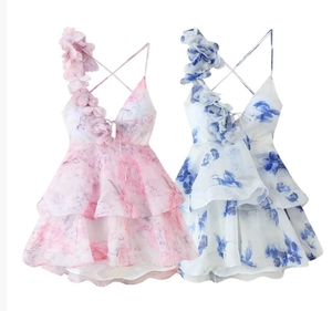 Detailed view of 3D floral petals on the waist of a pink and blue tiered chiffon dress