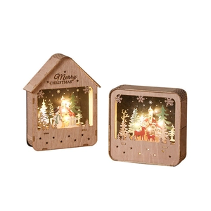 Lighted wooden Christmas house decoration with LED lights and festive snow scene