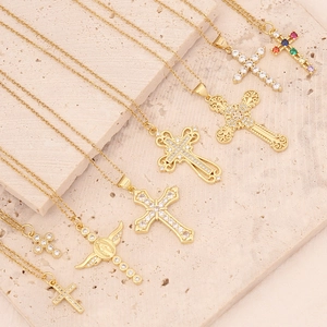 18K gold plated cross pendant necklace with micro-set zircon on beige stone backdrop