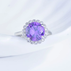 Close-up of 5ct purple gemstone ring with halo diamond setting on wave tray