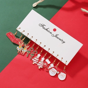 Detail of 9 pairs Christmas stud earrings set featuring Santa, tree, and reindeer charms