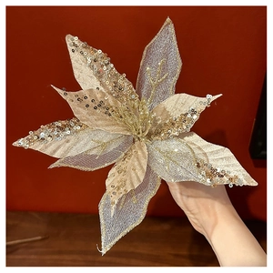 Close-up of champagne gold glitter poinsettia flower with mesh petals for Christmas trees