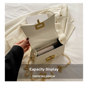 Interior capacity of white crossbody bag showing storage for phone and cosmetics