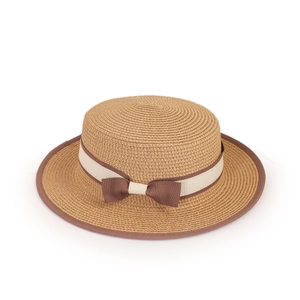 Detail of the braided straw boater hat featuring a two-tone bow and reinforced edge