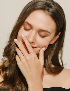 Close-up of minimalist s925 silver micro-pave ring worn on female model finger