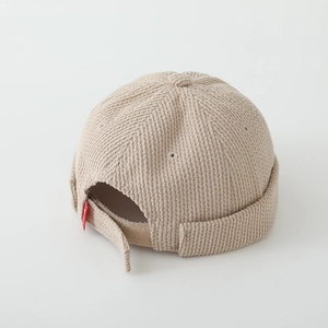 Detail of corduroy docker hat for boys showing adjustable strap and fabric texture