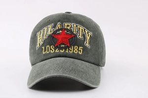 Close-up of yellow HILARITY embroidery on washed dark gray vintage cotton baseball cap