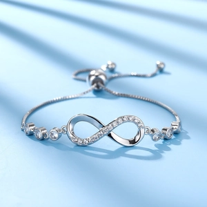 Detailed shot of infinity symbol silver bracelet with sparkling zircon stones and adjustable clasp